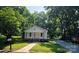 Charming home with well-maintained lawn, walkway, and mature trees providing ample shade at 616 Laurel St, Albemarle, NC 28001