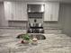 Modern kitchen featuring granite countertops, stainless steel appliances, and white cabinetry at 616 Laurel St, Albemarle, NC 28001