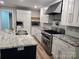 Spacious kitchen featuring an island with a sink, stainless steel appliances, and granite countertops at 616 Laurel St, Albemarle, NC 28001
