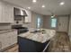 Open kitchen featuring an island with a sink, stainless steel appliances, and ample counter space at 616 Laurel St, Albemarle, NC 28001