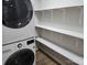 Bright laundry area features a new washer and dryer, wood-look flooring and shelving at 616 Laurel St, Albemarle, NC 28001