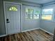 Sun room with lots of light, wood-look flooring and view to the front yard at 616 Laurel St, Albemarle, NC 28001