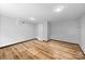 Spacious basement with wood-look flooring and neutral paint offers versatility for various uses at 6733 Candlewood Dr, Charlotte, NC 28210