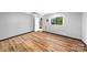Unfinished basement with wood-look flooring and neutral paint provides a blank canvas for customization at 6733 Candlewood Dr, Charlotte, NC 28210