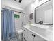Stylish bathroom featuring a modern vanity, decorative tile flooring, and a shower with subway tile and a blue curtain at 6733 Candlewood Dr, Charlotte, NC 28210