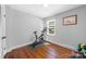 Spare bedroom with hardwood floors, a window for natural light, and a home gym with an exercise bike at 6733 Candlewood Dr, Charlotte, NC 28210