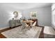 Sunlit dining room showcases a round table, four chairs, patterned wallpaper, and a large window with natural light at 6733 Candlewood Dr, Charlotte, NC 28210