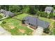 Aerial view of a well-manicured backyard with lush green grass, a wooden fence, and mature trees at 7627 Sarah Dr, Denver, NC 28037