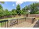 Wooden deck overlooking the spacious, fenced backyard with mature trees at 7627 Sarah Dr, Denver, NC 28037