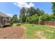 View of backyard featuring a trampoline, picnic table, fire pit, and a wooden fence at 7627 Sarah Dr, Denver, NC 28037
