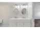Modern bathroom features double sink vanity with decorative mirrors, toilet, and tile flooring at 7627 Sarah Dr, Denver, NC 28037
