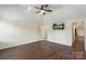 Spacious bedroom features vaulted ceiling, hardwood floors, ceiling fan, and TV at 7627 Sarah Dr, Denver, NC 28037