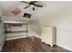 Bedroom with hardwood floors, ceiling fan, bunk bed, and dresser at 7627 Sarah Dr, Denver, NC 28037