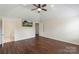 Spacious bedroom features vaulted ceiling, hardwood floors, ceiling fan, and TV at 7627 Sarah Dr, Denver, NC 28037