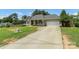 Charming single-story home featuring a covered front porch, gray siding, and a two-car garage at 7627 Sarah Dr, Denver, NC 28037