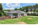 Well-maintained single-story home with a manicured lawn, fenced yard, and an attached two-car garage at 7627 Sarah Dr, Denver, NC 28037