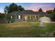 Charming single-story home featuring a covered front porch, gray siding, and a two-car garage at 7627 Sarah Dr, Denver, NC 28037