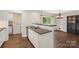 Updated kitchen features stainless steel appliances, white cabinets, and access to the dining and laundry room at 7627 Sarah Dr, Denver, NC 28037
