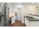 Updated kitchen features stainless steel appliances, white cabinets and access to the laundry room at 7627 Sarah Dr, Denver, NC 28037
