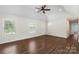 Spacious and bright living room featuring hardwood floors, large windows, and a ceiling fan at 7627 Sarah Dr, Denver, NC 28037