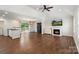 Open-concept living room featuring hardwood floors, a fireplace, and sliding doors leading to the outdoors at 7627 Sarah Dr, Denver, NC 28037