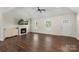 Bright living room features hardwood floors, white trim, fireplace with television, and neutral paint at 7627 Sarah Dr, Denver, NC 28037