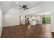 Bright living room with hardwood floors, a ceiling fan, and a view of the kitchen and backyard at 7627 Sarah Dr, Denver, NC 28037