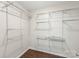 Walk-in closet with custom shelves and hardwood floors at 7627 Sarah Dr, Denver, NC 28037