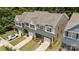 Charming townhomes boast inviting curb appeal with neat lawns and attached garages in a serene, wooded community at 8042 Saluda Dr, Charlotte, NC 28269