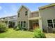 Backyard featuring a green lawn, landscaping, and a view of the home's exterior at 8042 Saluda Dr, Charlotte, NC 28269