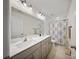 Bathroom with a double sink vanity, modern fixtures, and a shower/tub combo at 8042 Saluda Dr, Charlotte, NC 28269