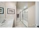 Neutral bathroom features a frameless glass shower and chrome fixtures at 8042 Saluda Dr, Charlotte, NC 28269