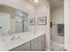 Bathroom with a double sink vanity, modern fixtures, and a shower at 8042 Saluda Dr, Charlotte, NC 28269