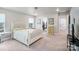 Bright bedroom with a white bed, neutral carpet, and walk-in closet offers comfort and storage at 8042 Saluda Dr, Charlotte, NC 28269