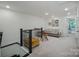 Well-lit upper-level hallway with seating area at 8042 Saluda Dr, Charlotte, NC 28269