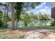 Picturesque view of a lake from the backyard with a walkway and lush green landscape at 8135 Cedar Glen Dr, Charlotte, NC 28212
