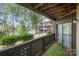 Private balcony overlooking a scenic lake with mature trees and lush green landscaping at 8135 Cedar Glen Dr, Charlotte, NC 28212