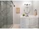 This bathroom has a walk-in shower, a white vanity with storage, and an oval mirror at 8135 Cedar Glen Dr, Charlotte, NC 28212