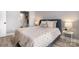 This primary bedroom features wood floors, a queen bed, neutral colors, and a bathroom view at 8135 Cedar Glen Dr, Charlotte, NC 28212
