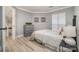 This secondary bedroom features wood floors, a full bed, a dresser, and large window at 8135 Cedar Glen Dr, Charlotte, NC 28212