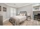 This spacious secondary bedroom features wood floors, a full bed, and a small desk at 8135 Cedar Glen Dr, Charlotte, NC 28212