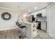 Modern kitchen with white cabinetry, bar seating, and stainless steel appliances at 8135 Cedar Glen Dr, Charlotte, NC 28212