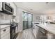 Bright kitchen featuring stainless steel appliances, white marble counters, and a sliding door at 8135 Cedar Glen Dr, Charlotte, NC 28212