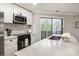 Well-lit kitchen with white countertops, stainless steel appliances, and a view of the backyard at 8135 Cedar Glen Dr, Charlotte, NC 28212