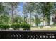 Serene lake view from a balcony, showcasing the natural beauty of the surrounding trees and water at 8135 Cedar Glen Dr, Charlotte, NC 28212