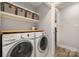 Bright laundry room featuring a modern washer and dryer, shelving, and access to another room at 8135 Cedar Glen Dr, Charlotte, NC 28212