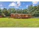 Expansive backyard with a wooden deck, mature trees, and ample space for outdoor activities at 8706 Richardson King Rd, Waxhaw, NC 28173