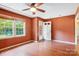 Empty bedroom with hardwood floors, natural light from windows, and a door leading to the outside at 8706 Richardson King Rd, Waxhaw, NC 28173
