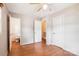 Light-filled bedroom featuring wood-look floors, two closets, and easy access to a half bathroom at 8706 Richardson King Rd, Waxhaw, NC 28173