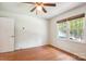 This sunny bedroom is complete with a ceiling fan and wood-look floors at 8706 Richardson King Rd, Waxhaw, NC 28173